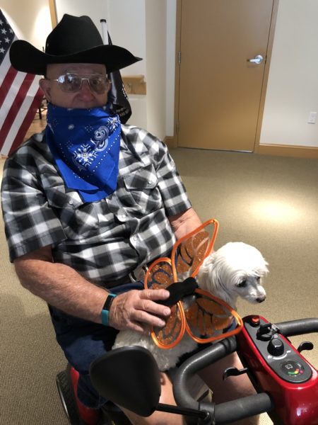 Halloween - a senior man with the dog