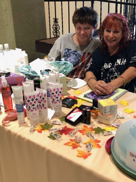 Fall Craft Bazaar - two women are sitting near the table with cosmetics